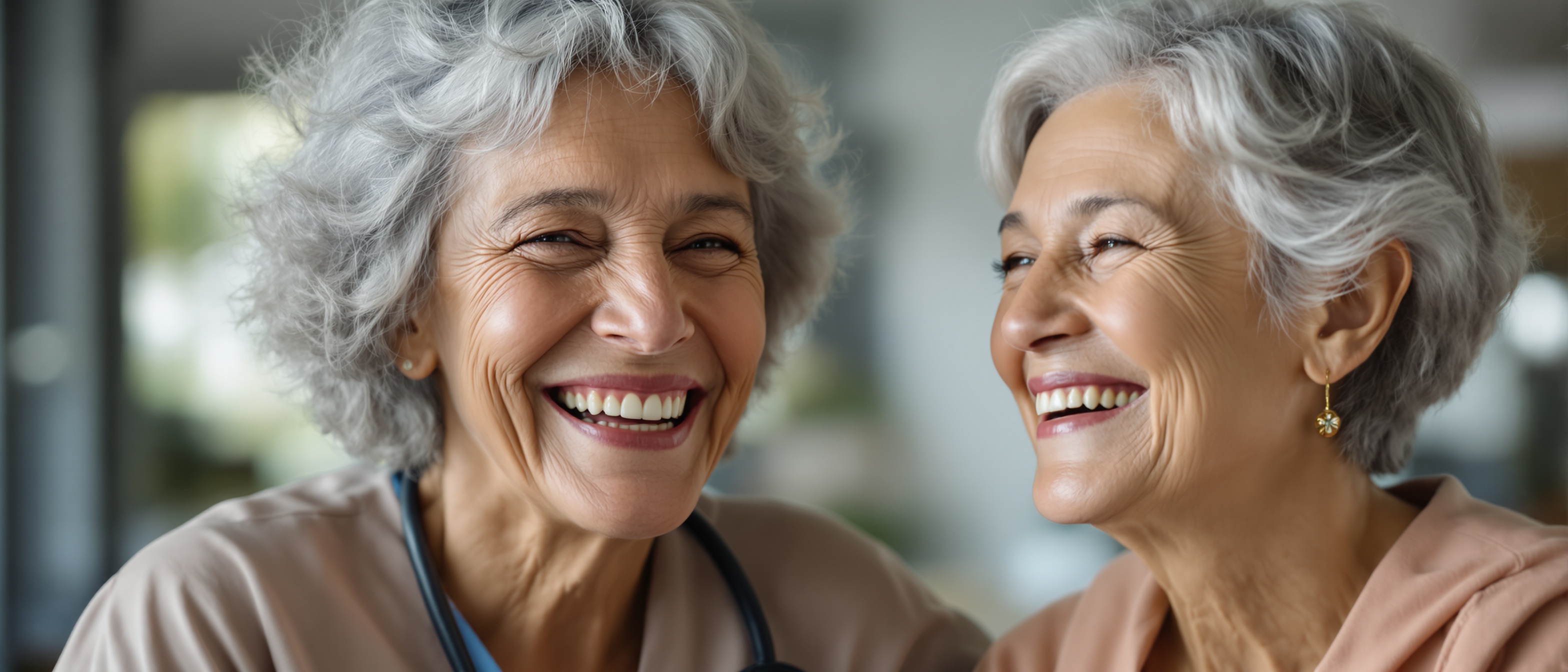 Elderly mother laughing with nurse