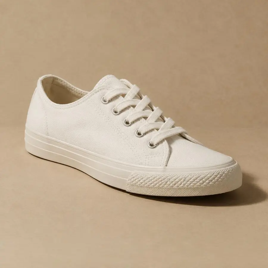 Unbranded white low-top canvas sneaker photographed on a plain white background