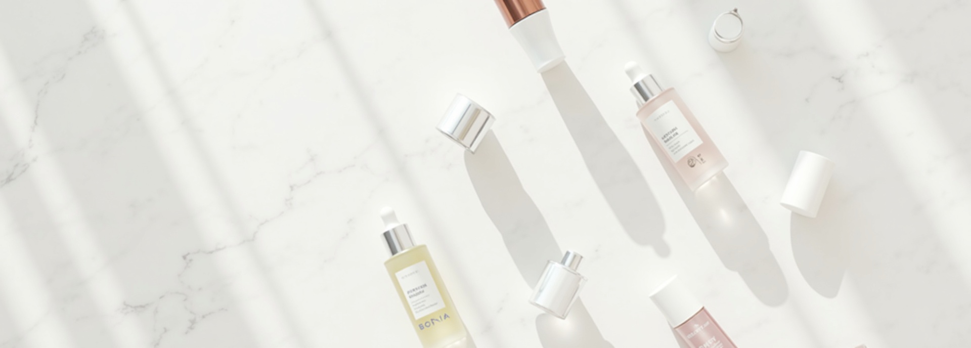 Diverse Korean skincare products including serums creams toners and sheet masks flat lay on white marble