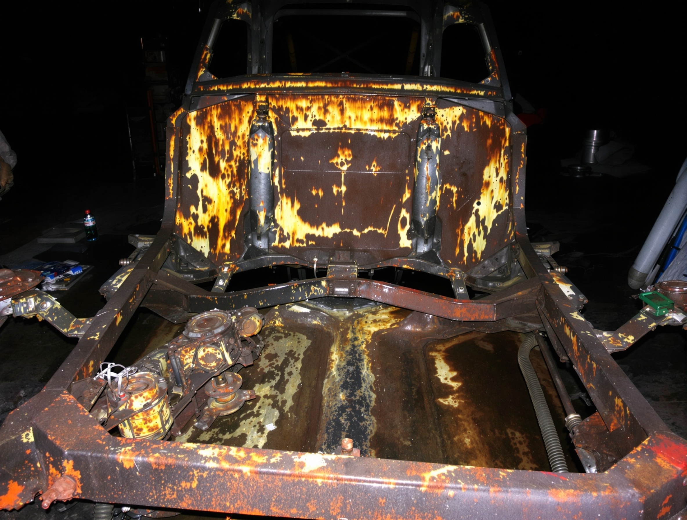 Old car chassis with paint and grime before stripping